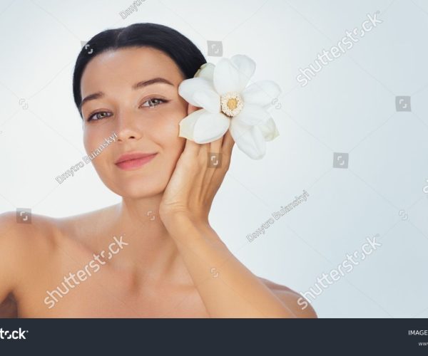 stock-photo-a-serene-young-woman-holds-a-white-flower-by-her-face-symbolizing-purity-and-elegance-her-smooth-2630959461
